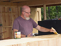 Mike Hayes painting the Cook Shed